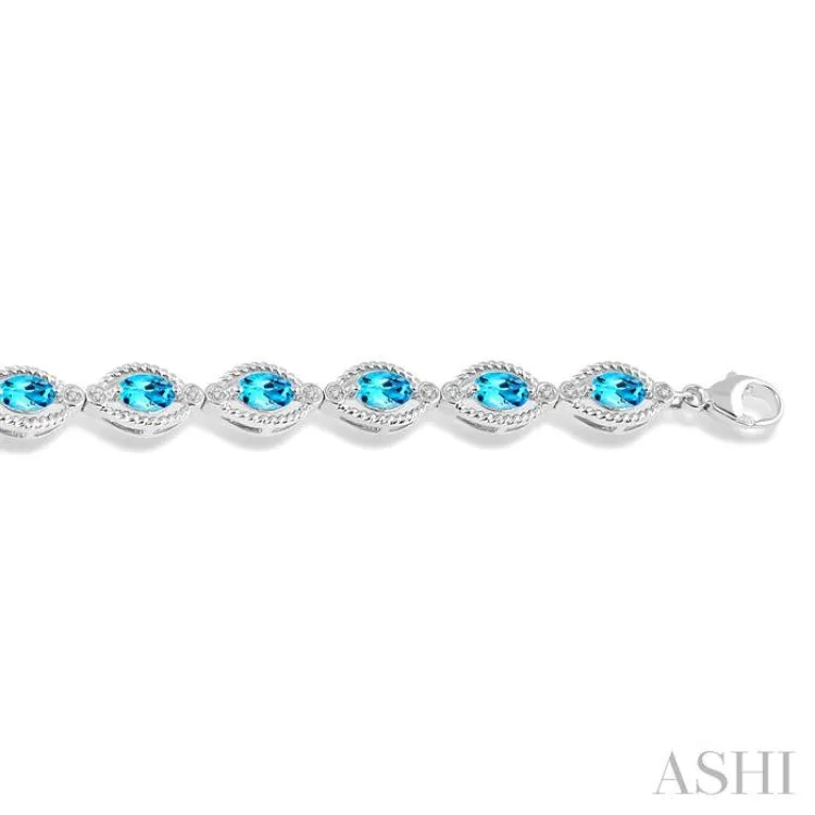 1/10 ctw Round Cut Diamond & 6x4MM Oval Cut Blue Topaz Semi Precious Bracelet in Silver